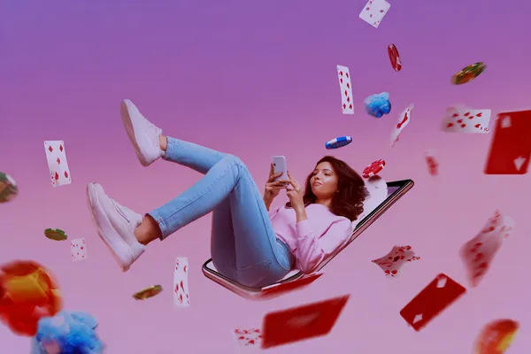 A young woman relaxing with her phone while dynamic casino elements float around her, illustrating the smooth mobile experience offered by the BDJL1 app.